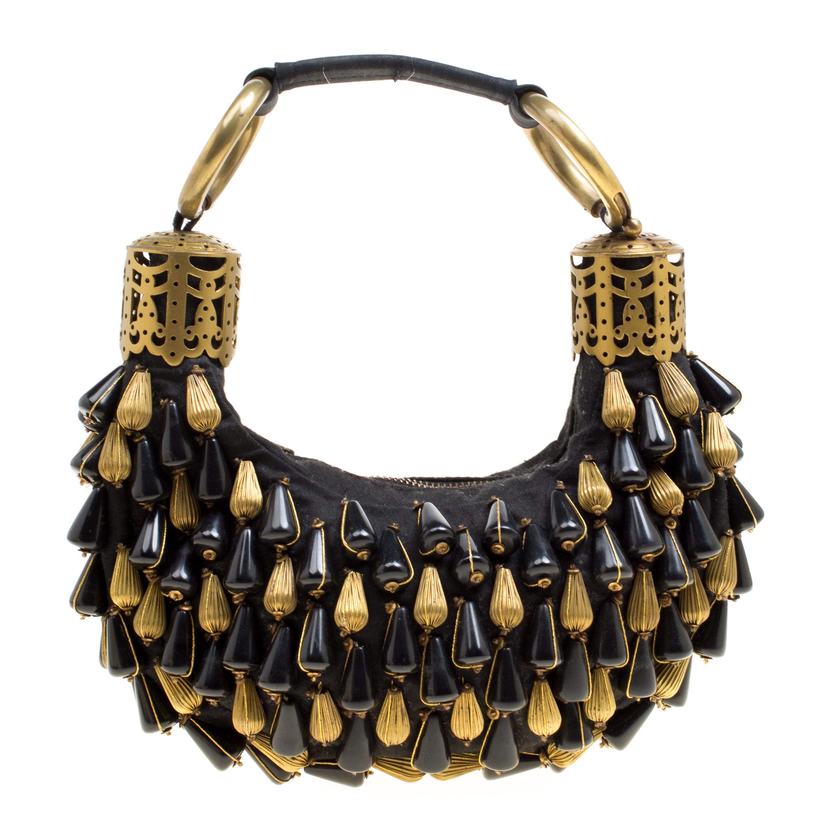 Why carry something ordinary when you can wear this gorgeous Crescent hobo by Chloe! This modern handbag is crafted from black fabric. It is heavily embellished with black and gold beads all over and a single handle that features ornate detailing.