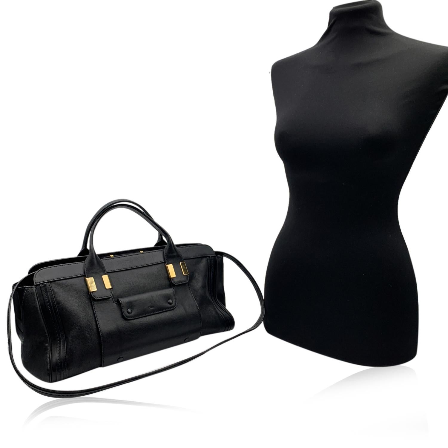 Gorgeous CHLOE 'Alice' bag crafted in genuine leather in a black color. This bag features two leather handles and removable shoulder strap. Open pocket and Flap pocket with button closure on the front. Upper zipper closure. Black fabric lining. 1