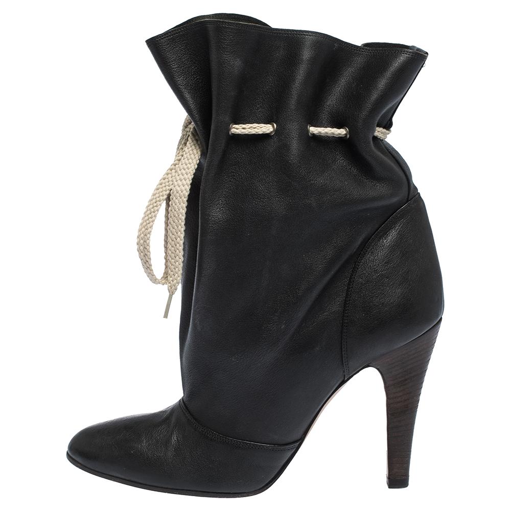 Durable and sophisticated, these booties from Chloe are a must-buy for the fashionable you. These boots are crafted in leather and come balanced on 10 cm heels. They are fashioned with round toes and drawstring tie detail.

Includes:Original Box,