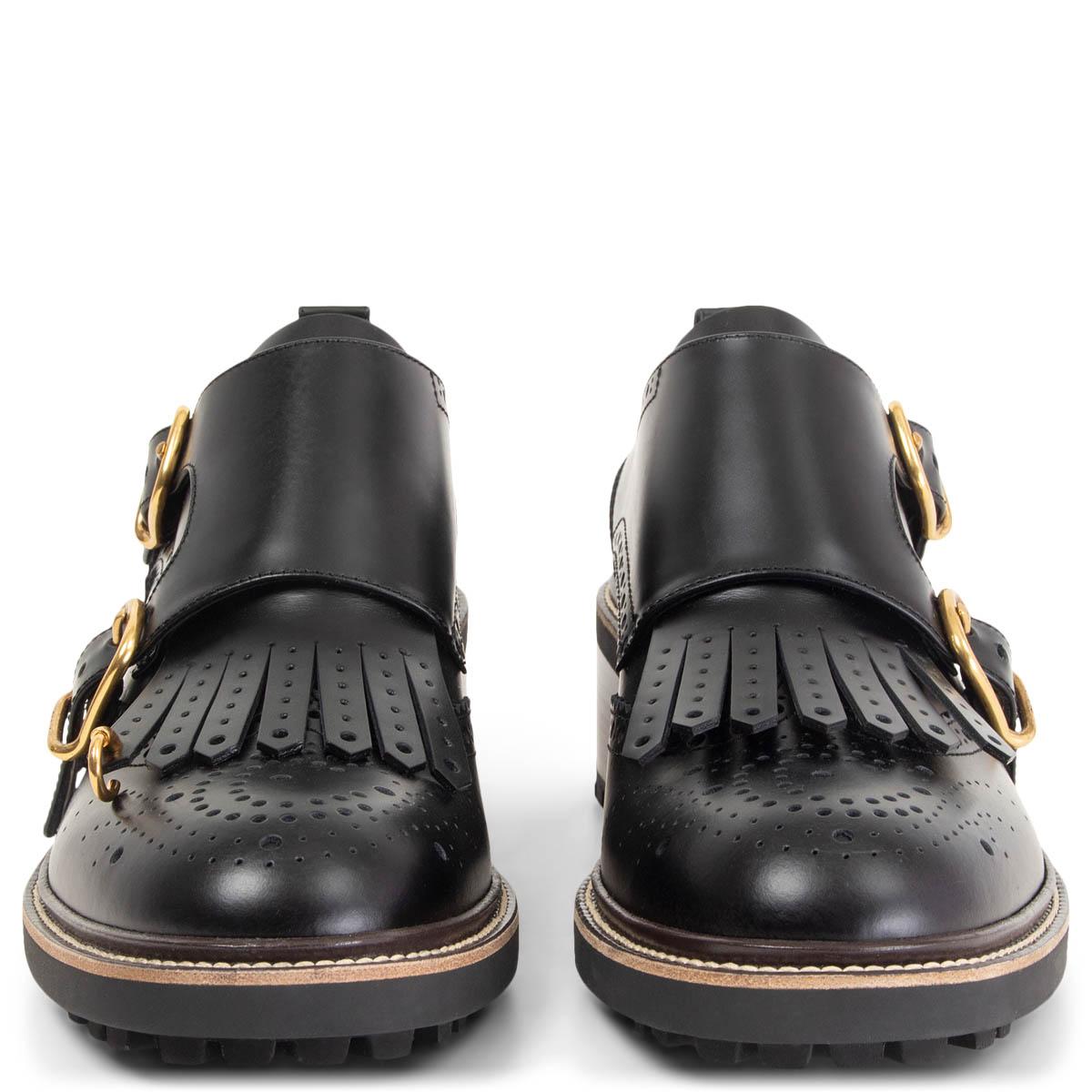 100% authentic Chloé Franne monk-strap block-heel loafers in black calfskin featuring gold-tone hardware with pierced kiltie fringe subverts the traditional menswear styling of a monk-strap brogue crafted with a contrasting welt, stacked block heel