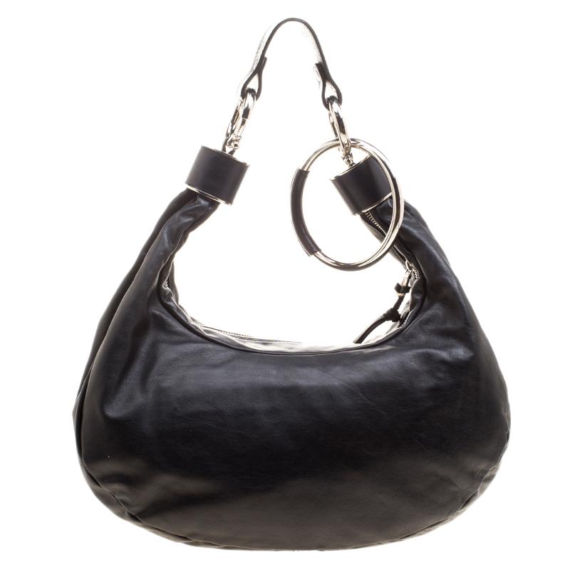 While you are waiting for the big party to come it is very definite to accessorize with this glittery hobo from Chloe. It is made from exotic leather and is studded with metal and crystal embellishment forming the flower shaped silhouette. The