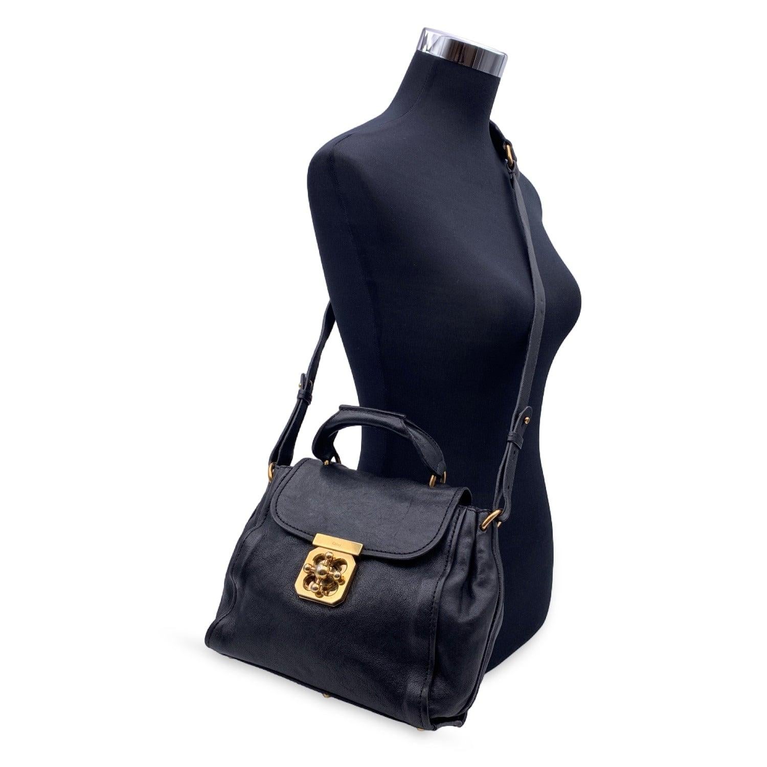 Gorgeous CHLOE 'Elsie ' crafted in genuine leather in black color. Gold metal hardware. Flap with twist closure on the front. 1 rear zip pocket. The interior is done in canvas textile and includes 1 smaller open pocket inside. 'CHLOE' embossed on
