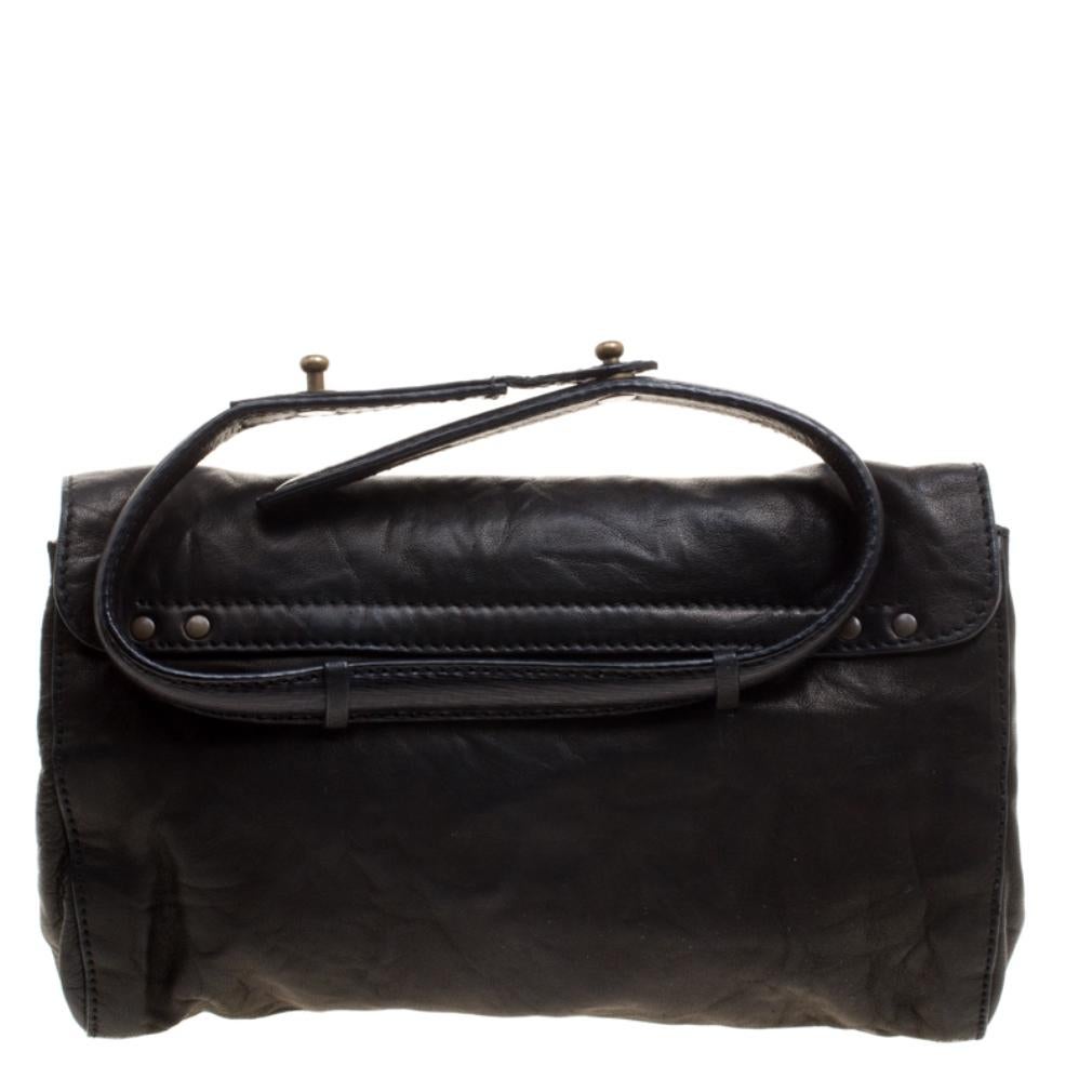 This black clutch has been meticulously crafted from leather and the front flap opens to reveal a well-sized interior that will hold all your party essentials. This piece comes with a gold bow detail on the front and totally deserves a place in your