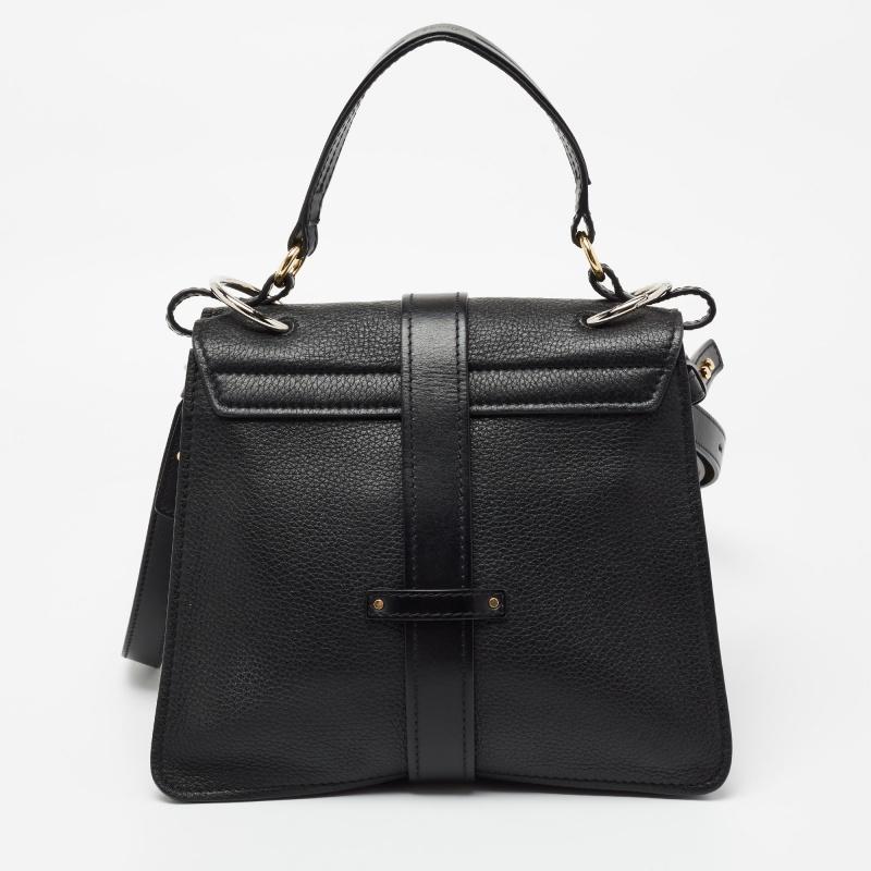 With an affinity to create chic bags that look like works of art, Chloe brings this Aby Day bag that is just a masterpiece. Crafted from leather, it presents itself in a black hue. It is styled with a front flap that carries a padlock and opens to a