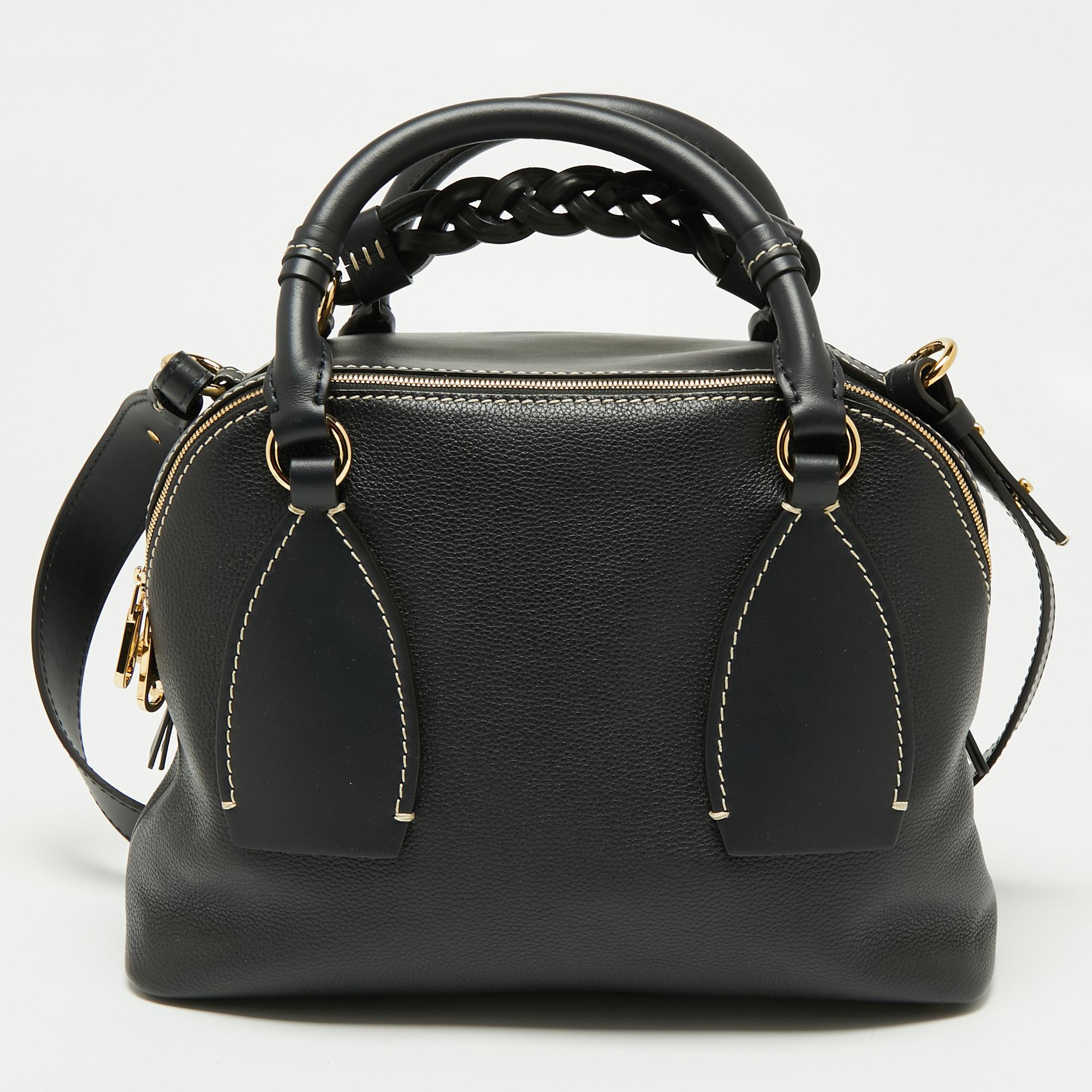 This Daria satchel from Chloe is designed in such an adorable style you will fall for it at the very first instant. It is made from black leather and it comes with dual top handles and opens to a well-sized fabric interior. A braided handle