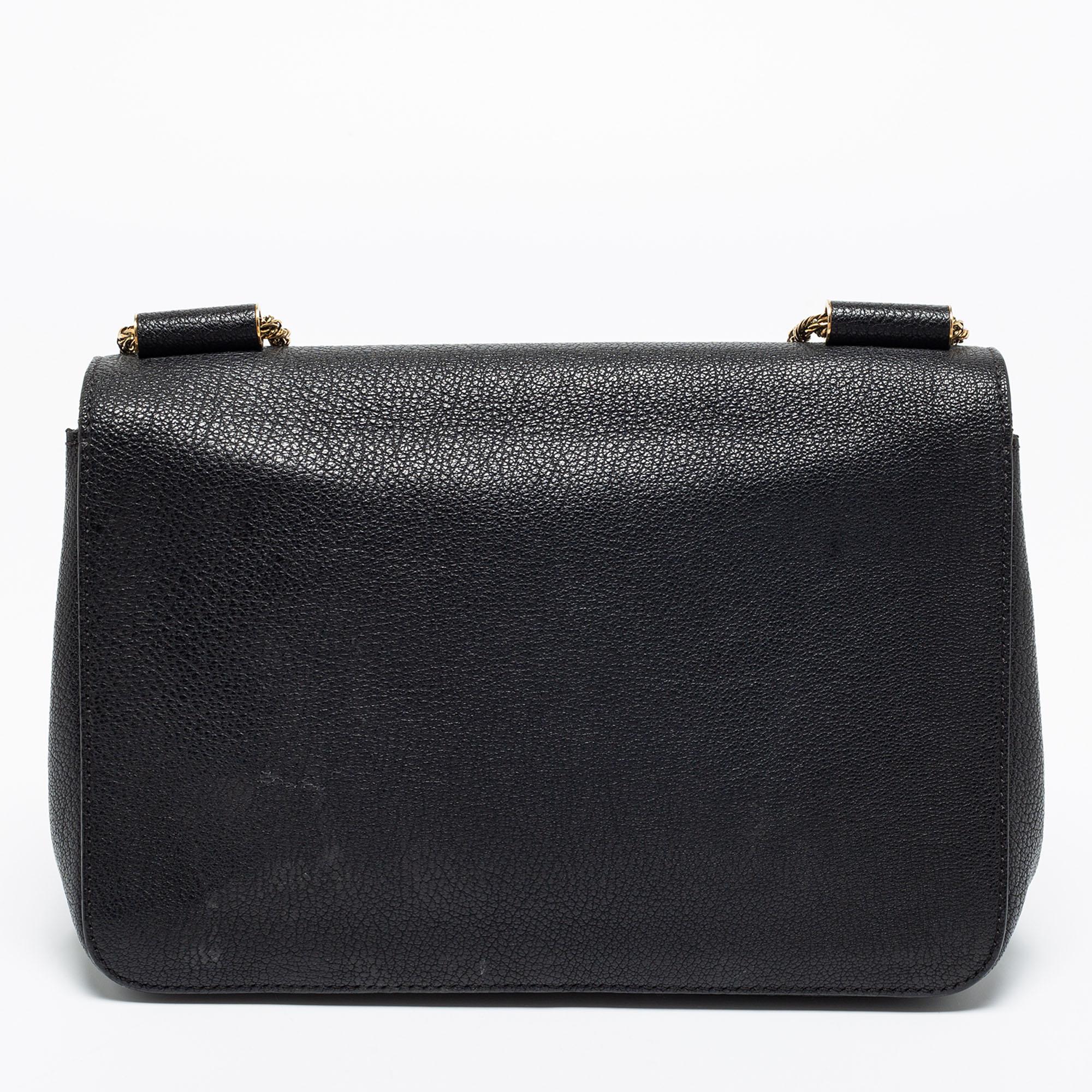 This grand Chloe Elsie bag has been crafted from black leather and styled with a flap. The bag is secured by a turn-lock and completed with a sliding chain. The wait for the perfect day bag ends with this one.
