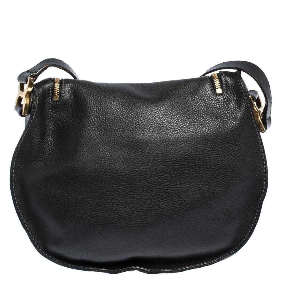 Stunning to look at and durable enough to accompany you wherever you go, this Chloe bag is a joy to own! This Marcie bag is crafted from black-hued leather with a well-designed front flap and a shoulder strap. The insides are fabric-lined and