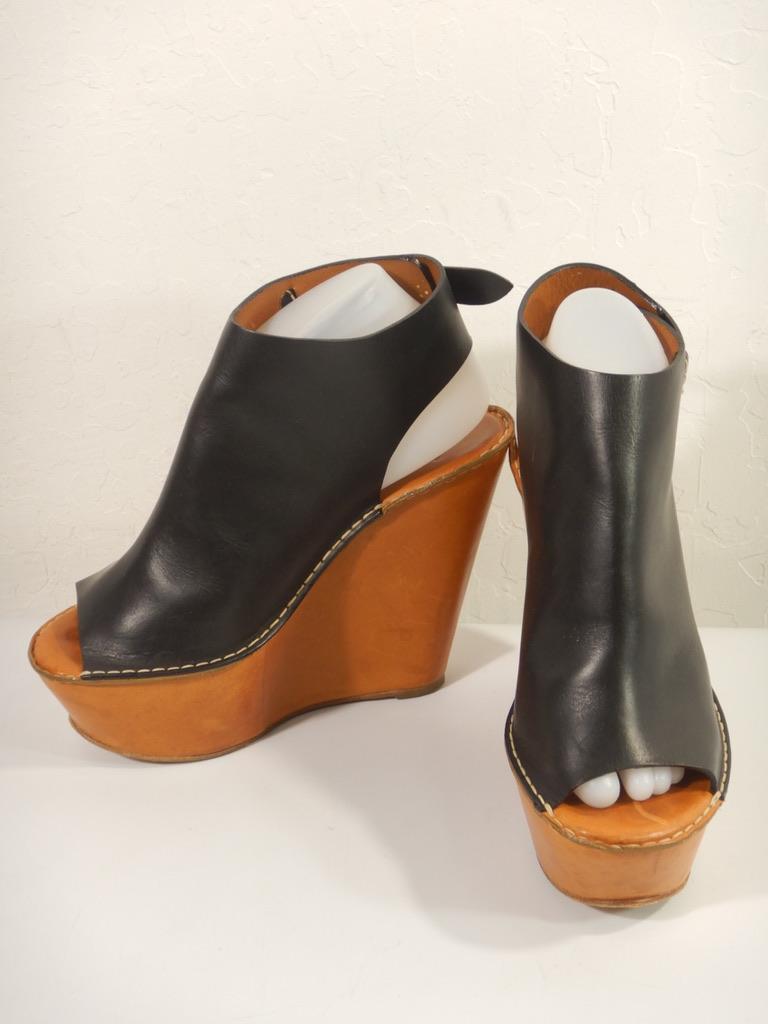 Chloe platform wedge clogs. Stamped size 38.5.

Black leather upper.

Open toe.

Leather sole in honey brown. 

The shoes are in good pre-worn condition. There is some patina and wear to the wedge soles. There is a scuff on one toe of the insole.