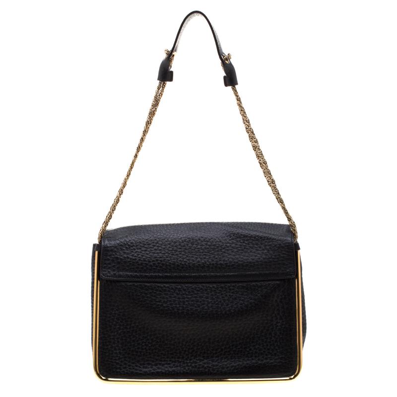 This stylish Sally shoulder bag from Chole is crafted from black leather. The bag features a chain link strap with leather shoulder rest and a stunning turn lock closure in gold-tone. The flap opens to a spacious canvas-lined interior that will keep