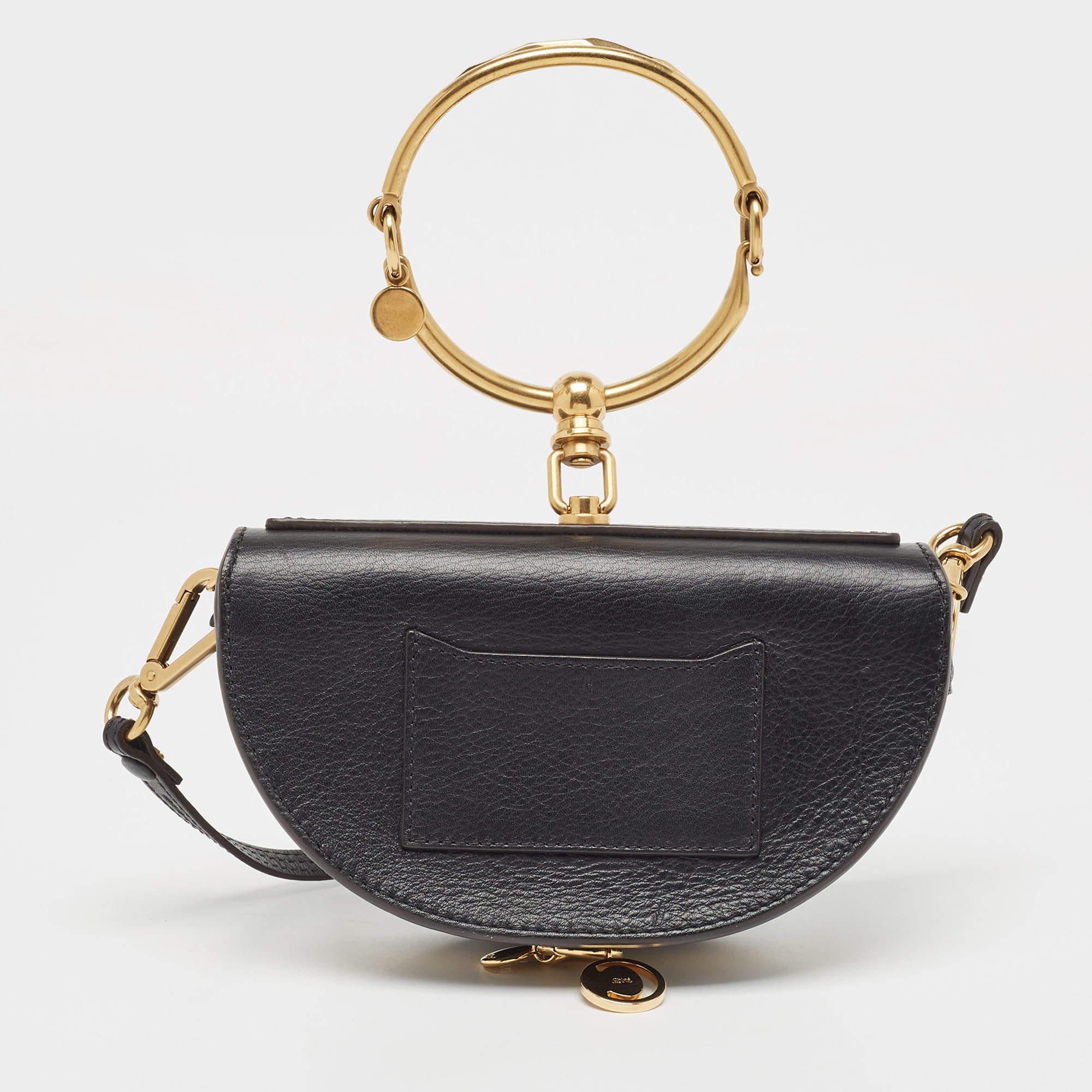 Loved by fashion influencers and celebs, this chic Nile bag by Chloé can become your most favorite bag, thanks to its unique half-moon-like shape and the bracelet handle. It has been crafted from leather and styled with a front flap that opens to an