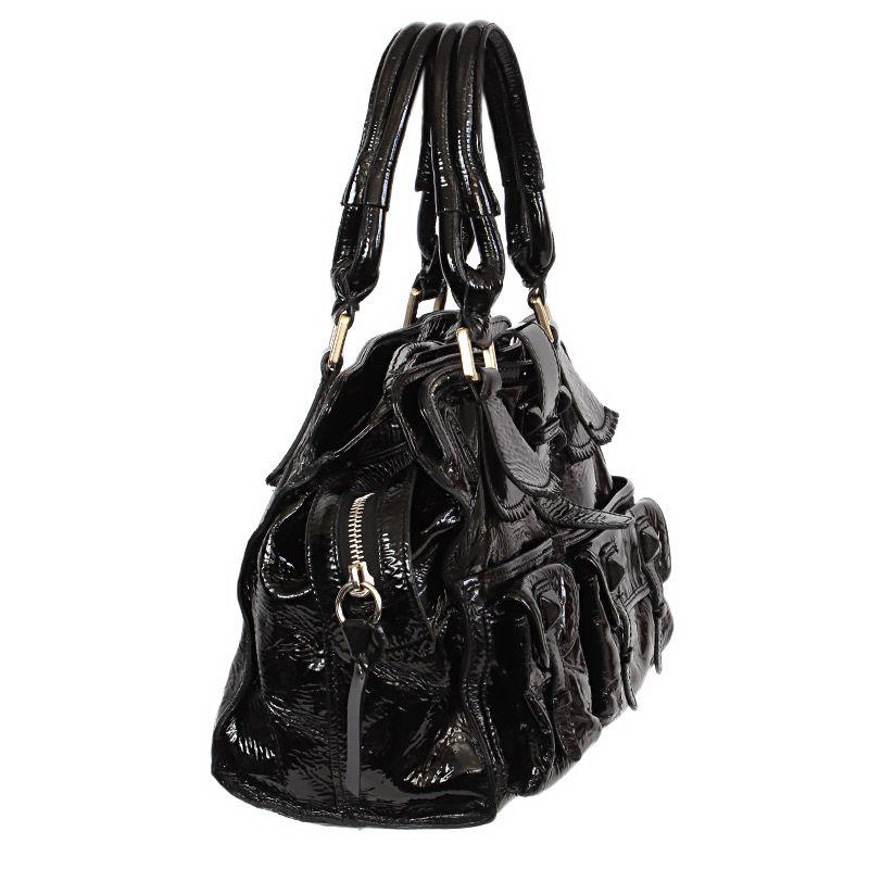 Chloé 'Elvire' shoulder bag in black patent leather with two outside pockets. Opens with a zipper on top. Lined in black fabric with a zipper pocket against the back. Has been carried with some signs of use to the edges. Overall in very good