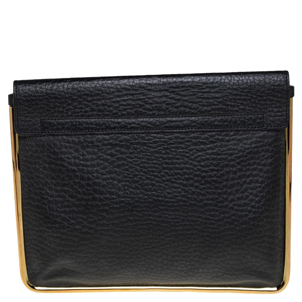 An envelop clutch is just the perfect thing to complement your evening party dress. This Sally clutch from the chic designs of Chloe is winsome. Crafted from black pebbled leather, it features a gold-tone metal trim. A shift lock flap closure opens