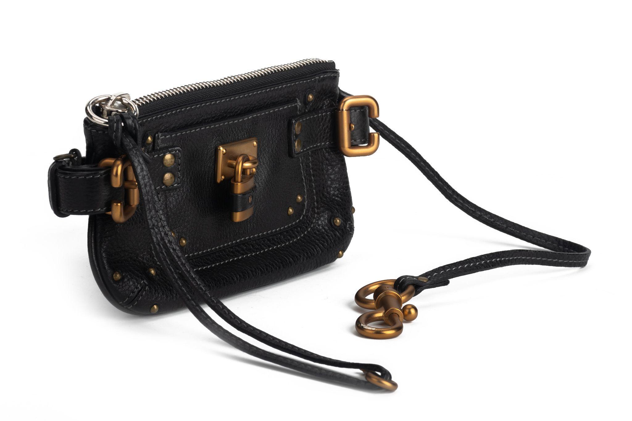 Chloe pochette bag in black with gold hard ware. The straps of the bag are adjustable to fit different sizes. It can be worn as a belt as well as crossbody. The piece is in excellent condition and comes with a dustcover.