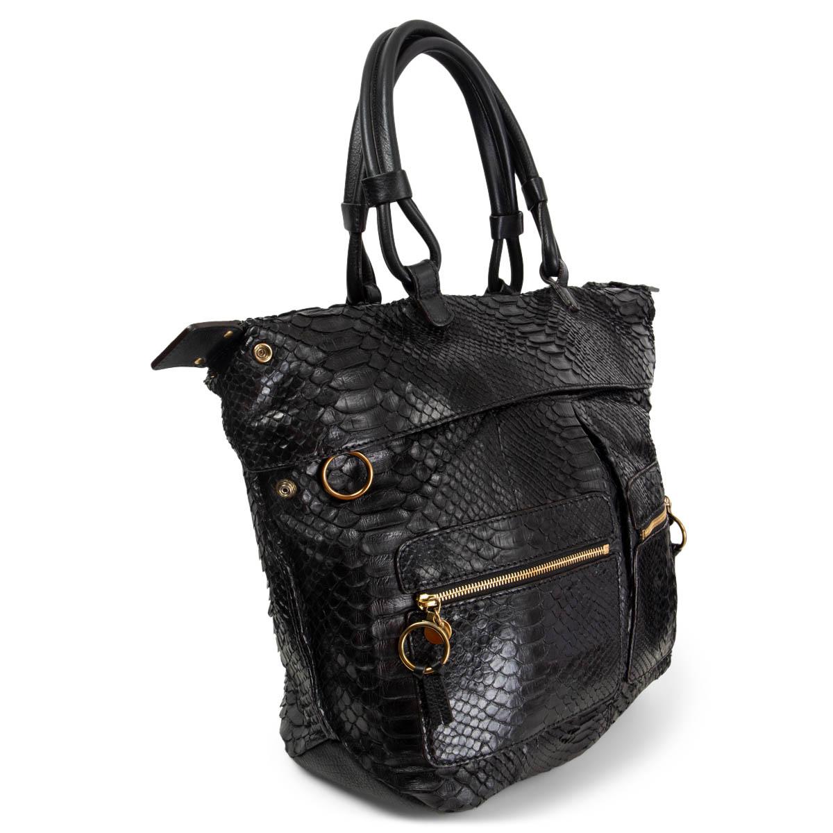 100% authentic Chloé shoulder bag in black python leather with two zipper patch pockets and a big zipper pocket at front. Opens with a zip on top and is lined in beige canvas with two open pockets. The design has two push buttons on the side for