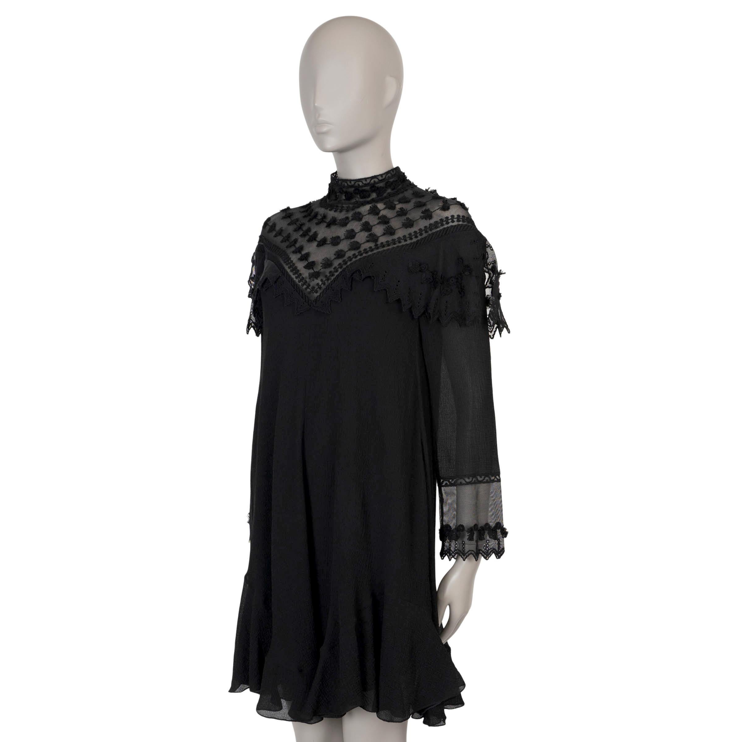 This 100% authentic Chloé dress in black crêpe silk exudes romantic elegance with intricate detailing. It features an embroidered lace panel and a relaxed, flared silhouette that flows beautifully. The mock neck and long sleeves with lace-trimmed