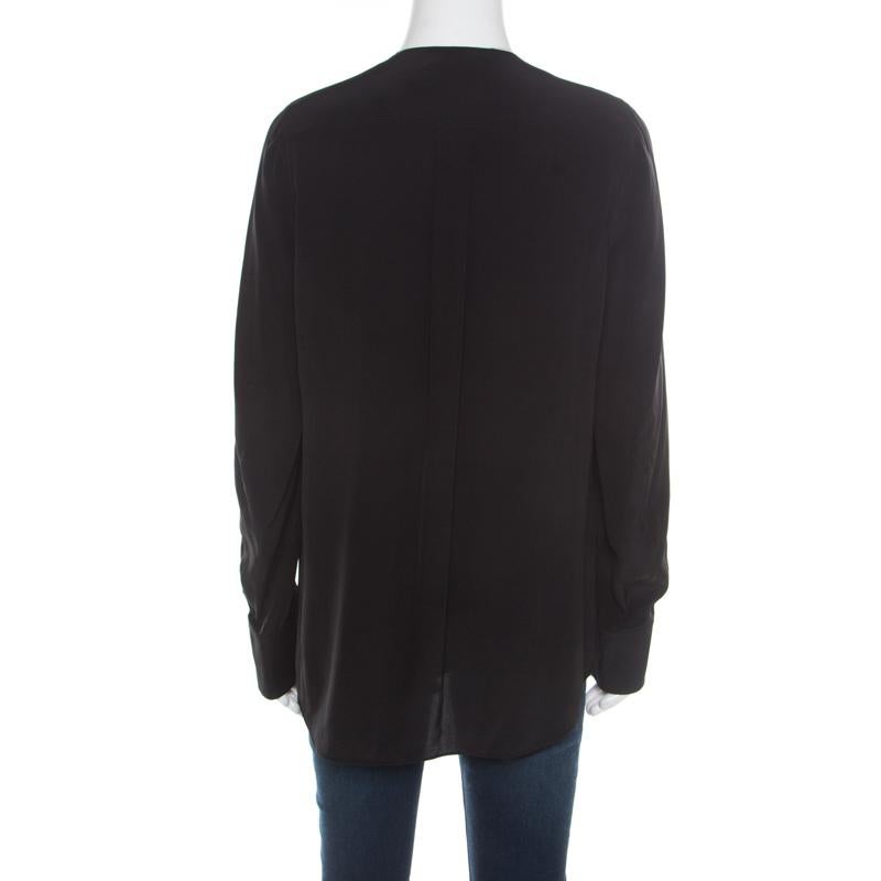 This blouse from Chloe is amazingly stylish! The black creation is made of 100% silk and features a front wrap silhouette. It flaunts a plunging neckline, front button fastenings and long sleeves. It is sure to lend you a flattering fit and can be