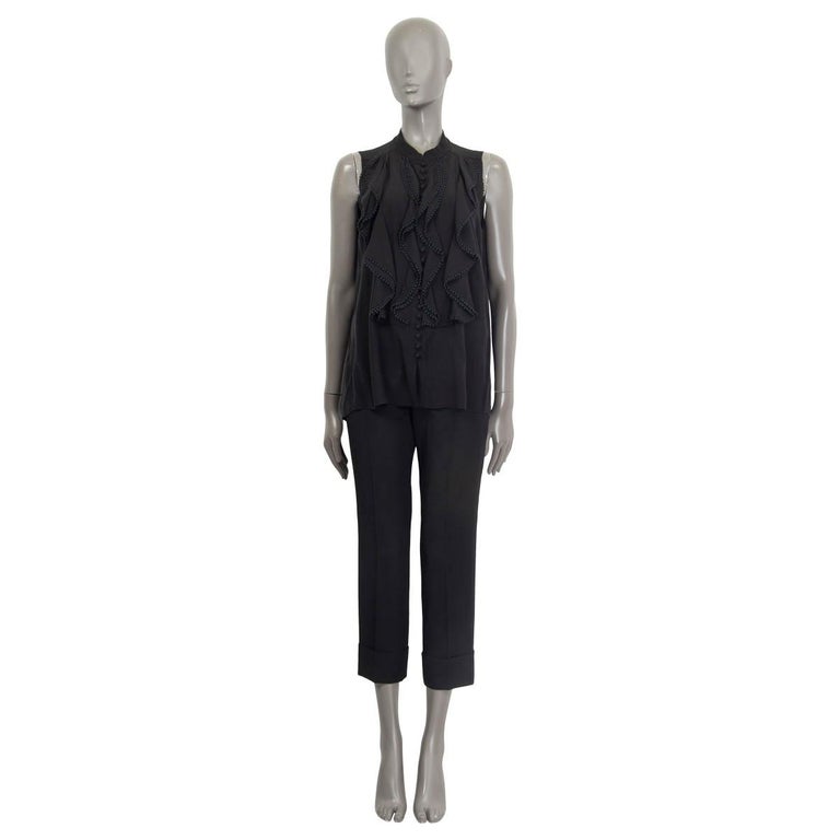 100% authentic Chloe sleeveless button down shirt in black silk (100%). Features ruffled details on the front and a round neck. Unlined. Has been worn and is in excellent condition. 

Measurements
Tag Size	40
Size	M
Shoulder Width	32cm