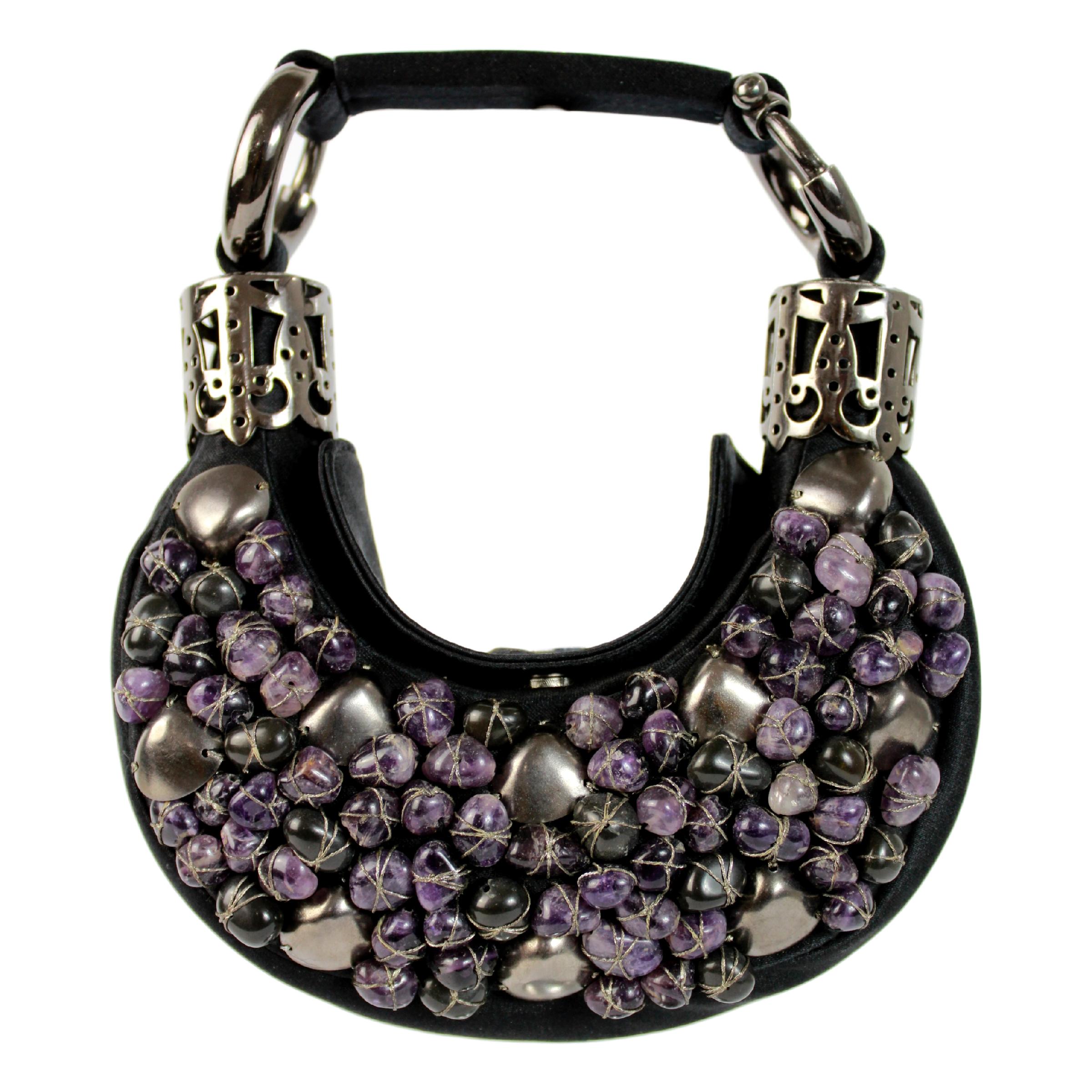Chloe evening handbag. Black jewelery clutch bag, covered with purple-colored hard stones, silver-colored handle, clip button closure, 2000s. Made in Italy. Excellent vintage condition

Width: 18 cm
Height: 9 cm
Depth: 3 cm
