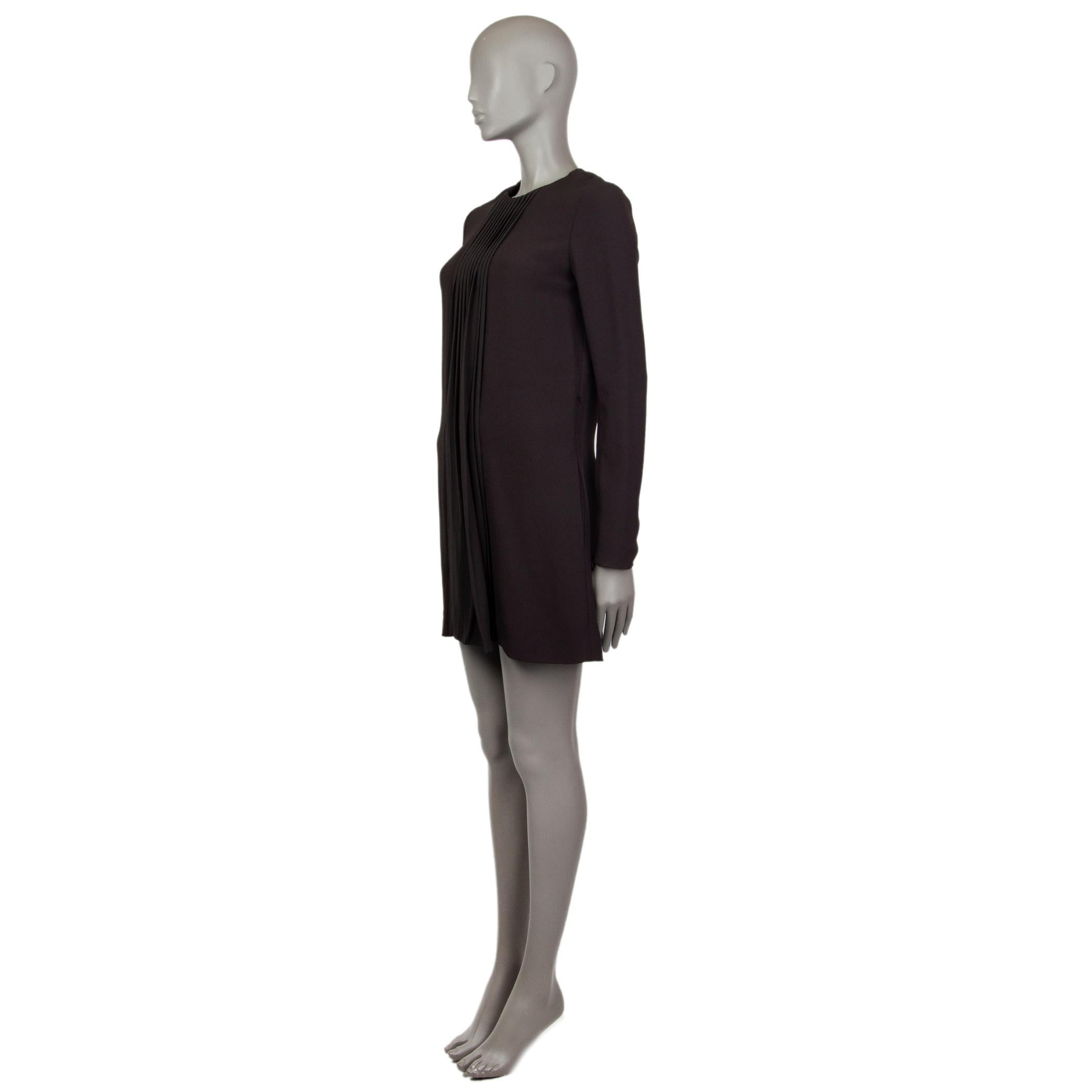 100% authentic Chloé long-sleeve shift dress in black viscose (53%) and acitate (47%). With pleated panel on the center front and two slit pockets on the sides. Features invisible zipper along the inner sleeves. Closes with a hock and has an