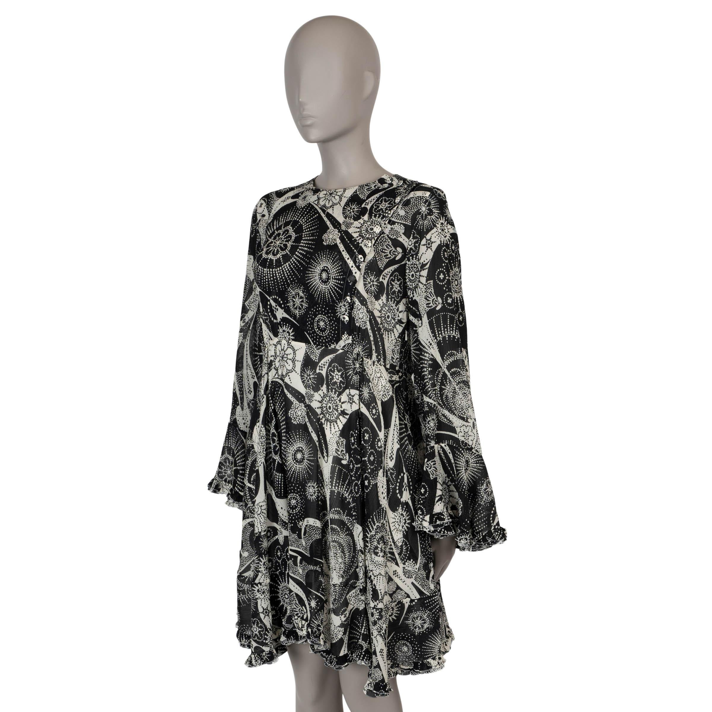This 100% authentic Chloé dress in black and white floral-printed semi-sheer crepe combines cotton (65%) and silk (35%) for a light, airy feel. It features a relaxed, flowy silhouette with a round neck, slit pockets on the side, elegant bell