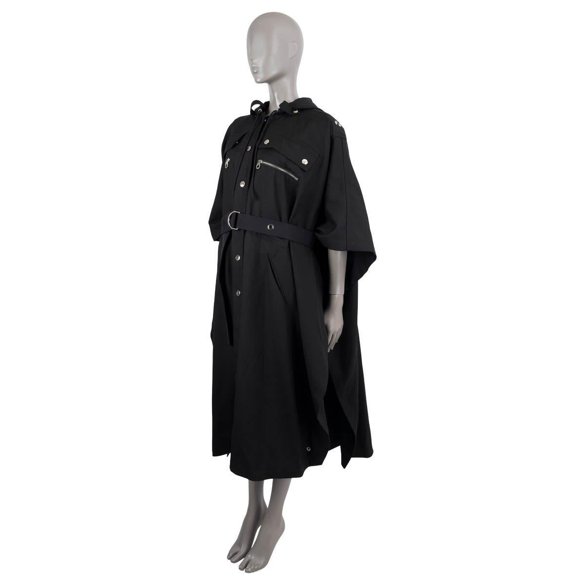 100% authentic Chloé hooded cape in black wool gaberdine (100%). Features a longline silhouette with cinched-in waist reminiscent of a parka, a belt, two zip pocket on the chest and on on the back. Can be converted to a sleeveless version with