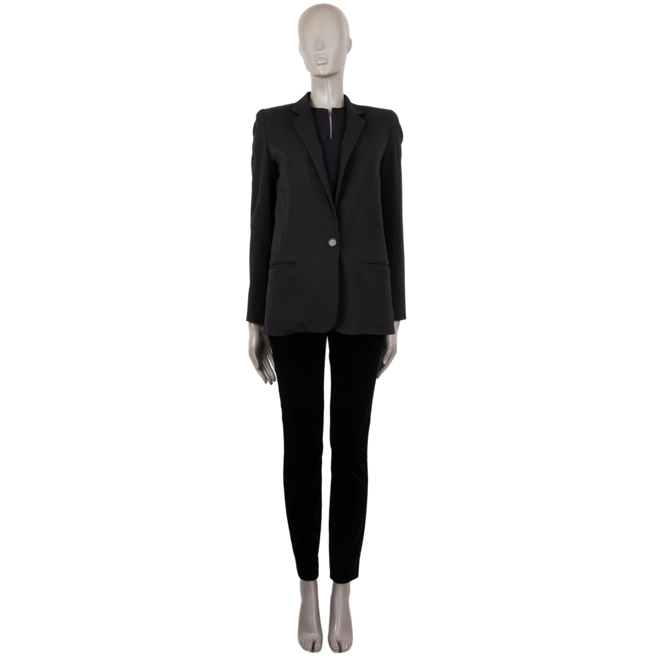 authentic Chloe classic blazer in black wool (90%), nylon (8%), and elastane (2%). With narrow notch collar, two welt pockets on the front, and three-button cuffs. Closes with one urea button on the front. Lined in black fabric. Has been worn and is
