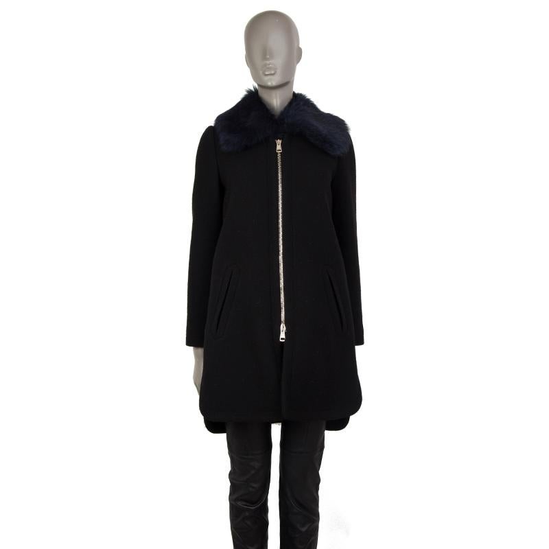 authentic Chloe collarless coat in black virgin wool (80%) and nylon (20%). With two pockets on the front. Features removable ruffled collar with midnight blue lambskin shearling. Closes with two-way silver-tone zipper on the front. Lined in nude