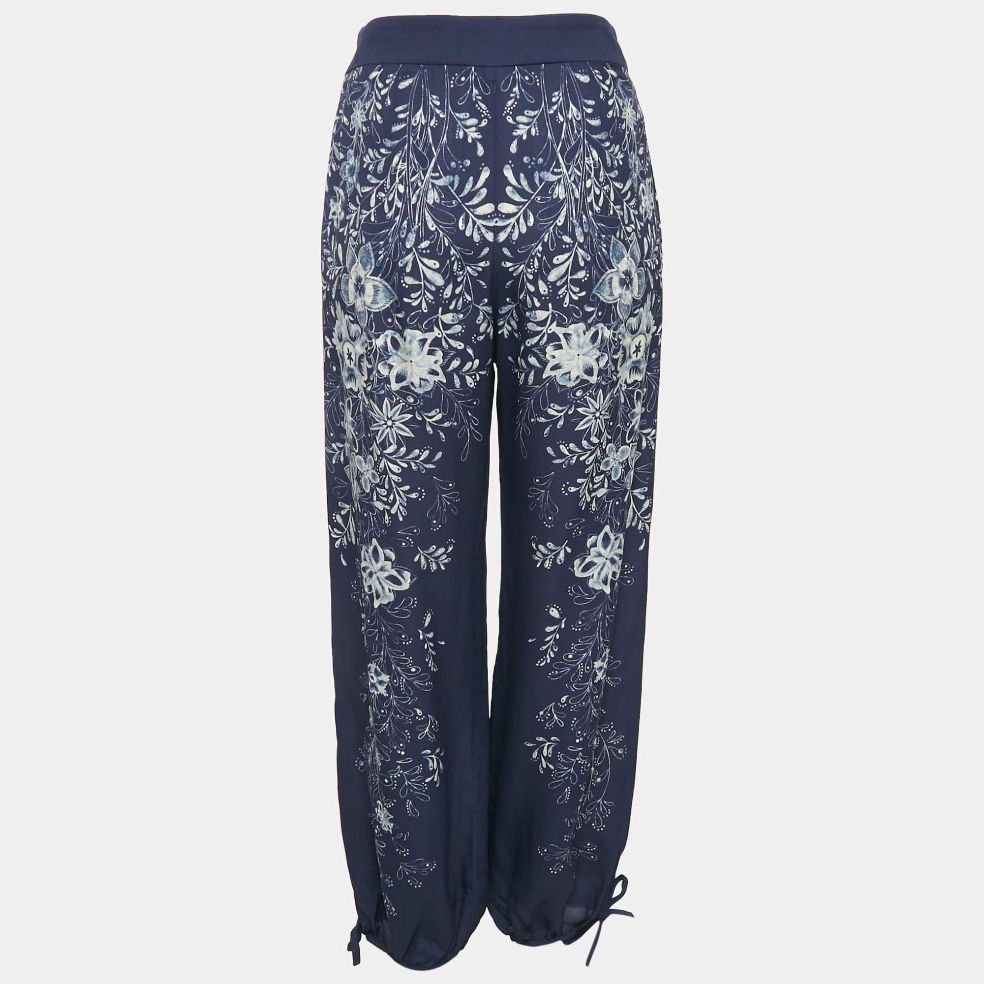 Experience effortless style with these Chloé blue and beige floral print crepe harem pants. Designed for comfort and versatility these pants feature a relaxed fit and delicate floral pattern perfect for dressing up or down. Pair them with a simple