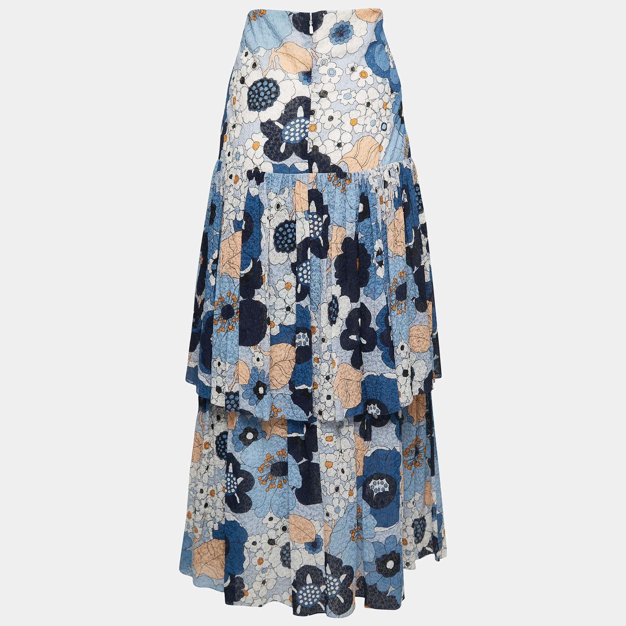 The Chloe skirt is a stunning piece that exudes feminine charm. With its vibrant blue color, delicate floral print, and textured cotton fabric, this skirt offers a stylish and comfortable option for any occasion. The tiered design adds movement and