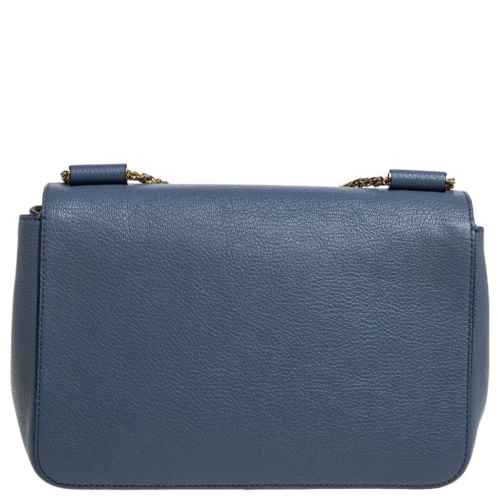 Every curve and detail on this Chloe Elsie is grand which adds to the worth of the bag. It has been crafted from leather and styled with a flap. The bag is secured by a turn-lock revealing a well-sized interior and completed with a top handle and a