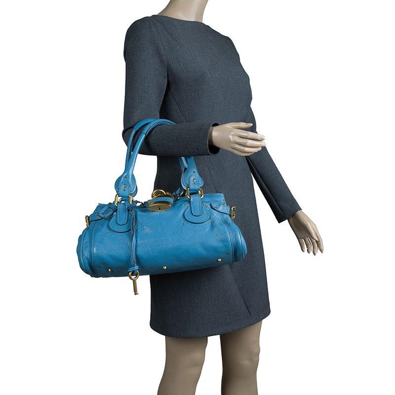 A favourite amongst celebrities, this Paddington Satchel rules the hearts of many young fashionistas. Composed of gorgeous blue leather, this bag features a slightly slouchy silhouette. It comes with dual rounded top handles and punctuated with