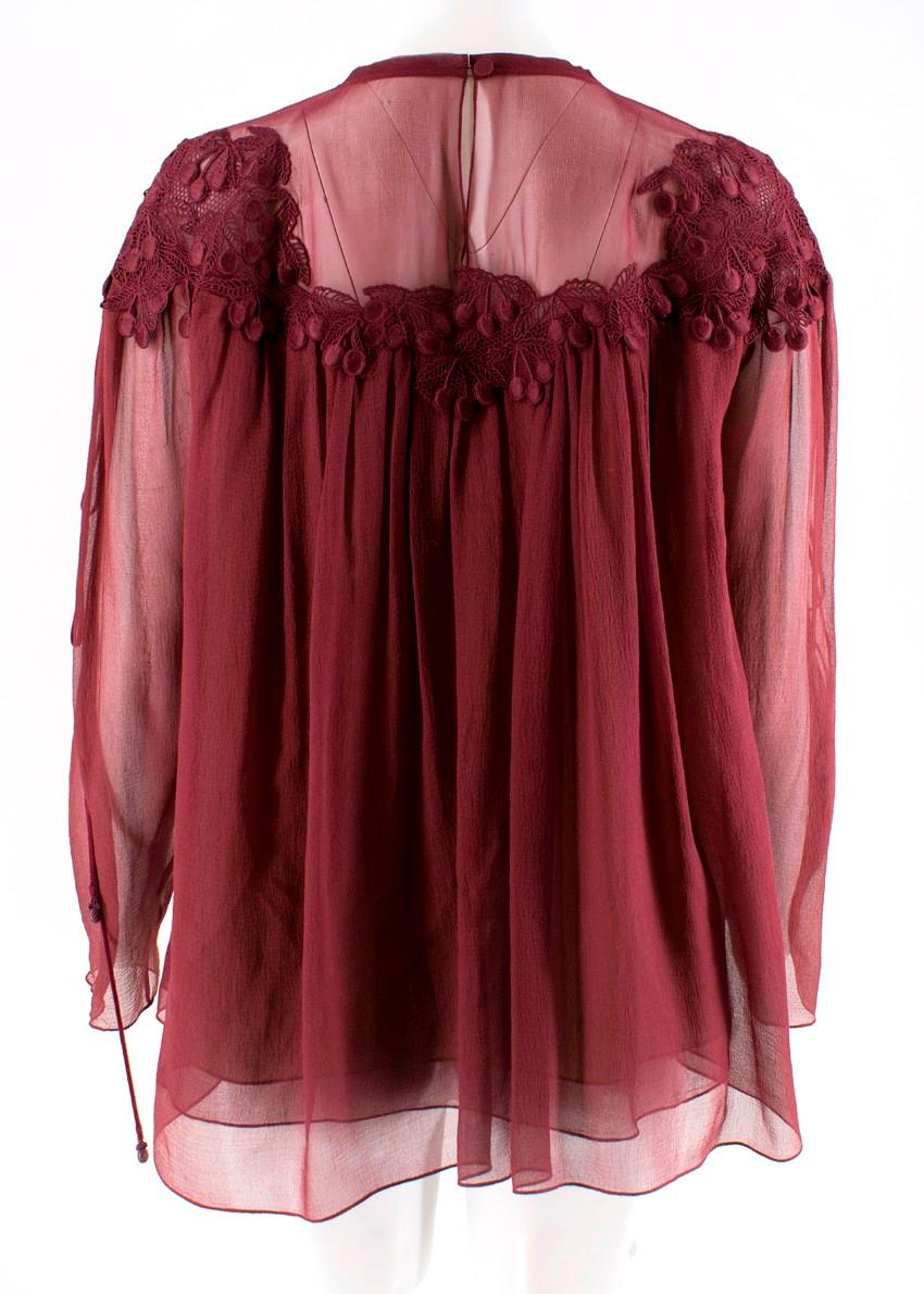 Chloe blouse featuring an elegant embroidered lace around the neck and long loose sleeves. RRP £1500

- Back button fastening
- Embroidered lace cherries
- Organza-silk on chest and sleeves
Main material:
- 100% silk
Main lining: 
- 100%