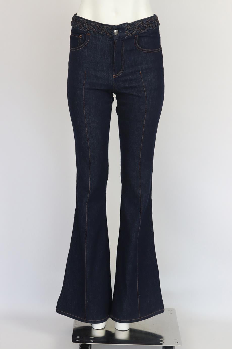 Chloé braided high rise flared denim jeans. Dark-blue. Button and zip fastening. 83% Cotton, 16% polyester, 1% elastane; patch: 100% leather; pocket lining: 65% polyester, 35% cotton. FR 36 (UK 8, US 4, IT 40). Waist: 28.2 in. Hips: 34 in. Length:
