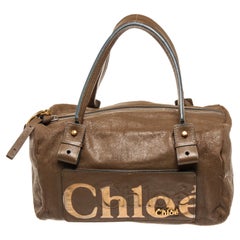 Chloe Bolso de viaje The Eclipse Bost de piel dorada marrón con logotipo de material de piel