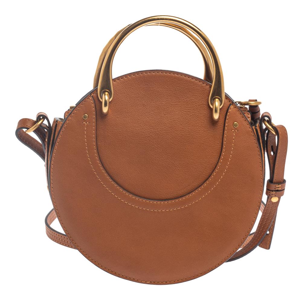 Give your totes and hobos a rest and opt for a light accessory when you're heading out with your friends or family, like this Pixie bag from Chloe! The leather and suede bag is cute and versatile in design. It flaunts a round shape, and it is held