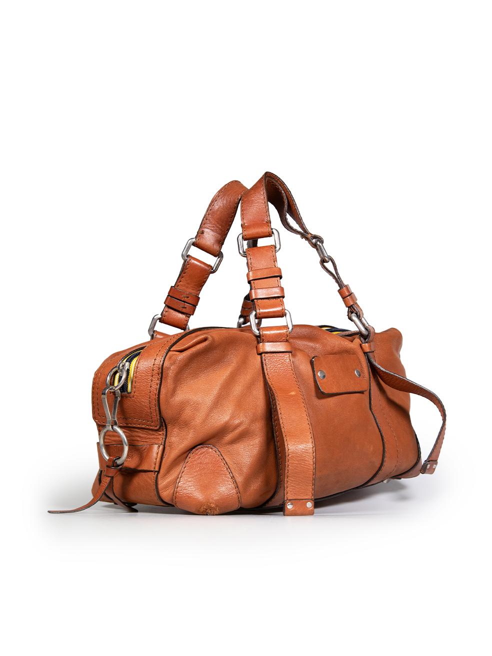CONDITION is Good. General wear to the bag is evident. Moderate creasing to the leather on all four base corners. Scratching on the front and discolouration on the front, back, back right rim, front top, back top, both handles and inner pocket zip