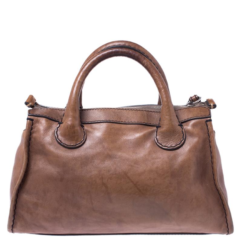 This exquisite Chloe bag is an unparalleled beauty. Crafted from leather, it comes in a lovely shade of brown. This Edith satchel features a structured silhouette, is held by dual handles, top zip closure that opens to a fabric-lined interior,