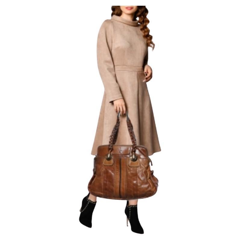 Coveted by fashionable women around the world, the Heloise is a bag worth the price. It is from the luxury brand, Chloe. The bag is crafted from brown leather and designed with braided handles, gold-tone hardware, and a spacious fabric interior.