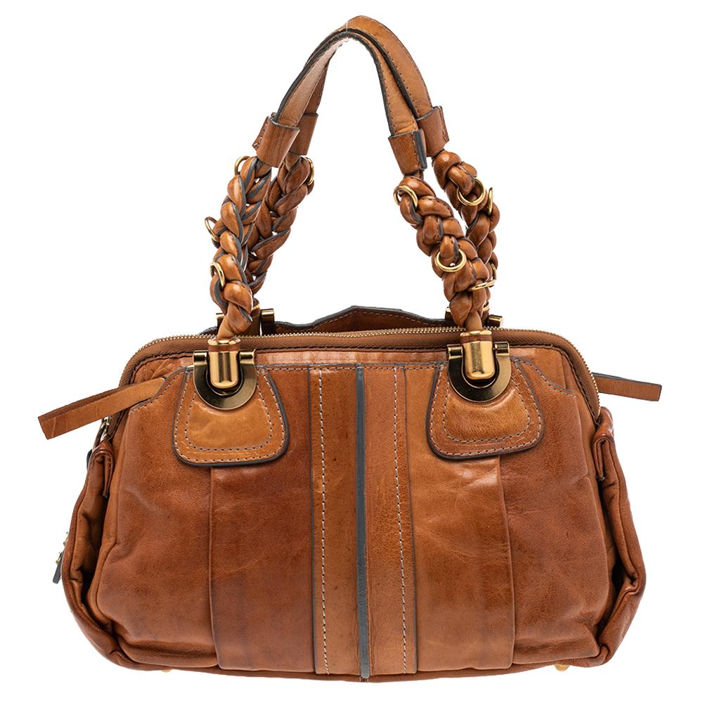 Coveted by fashionable women around the world, the Heloise is a bag worth the price. It is from the luxury brand, Chloe. The bag is crafted from brown leather and designed with braided handles, gold-tone hardware, and a spacious canvas