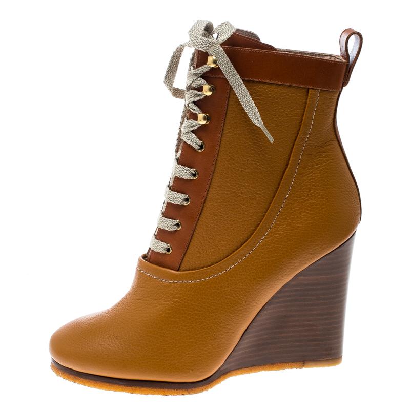 Chloe proves their high style and unique fashion taste with these edgy yet chic ankle boots. They are brimming with exquisite details like the smooth brown leather exterior with lace-ups, sturdy wedges, and the rubber soles. Grab this pair today and