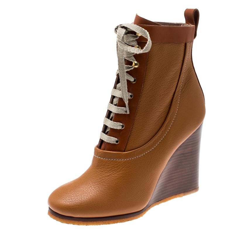 Chloe proves their high style and unique fashion taste with these edgy yet chic ankle boots. They are brimming with exquisite details like the smooth brown leather exterior with lace-ups, sturdy wedges, and the rubber soles. Grab this pair today and