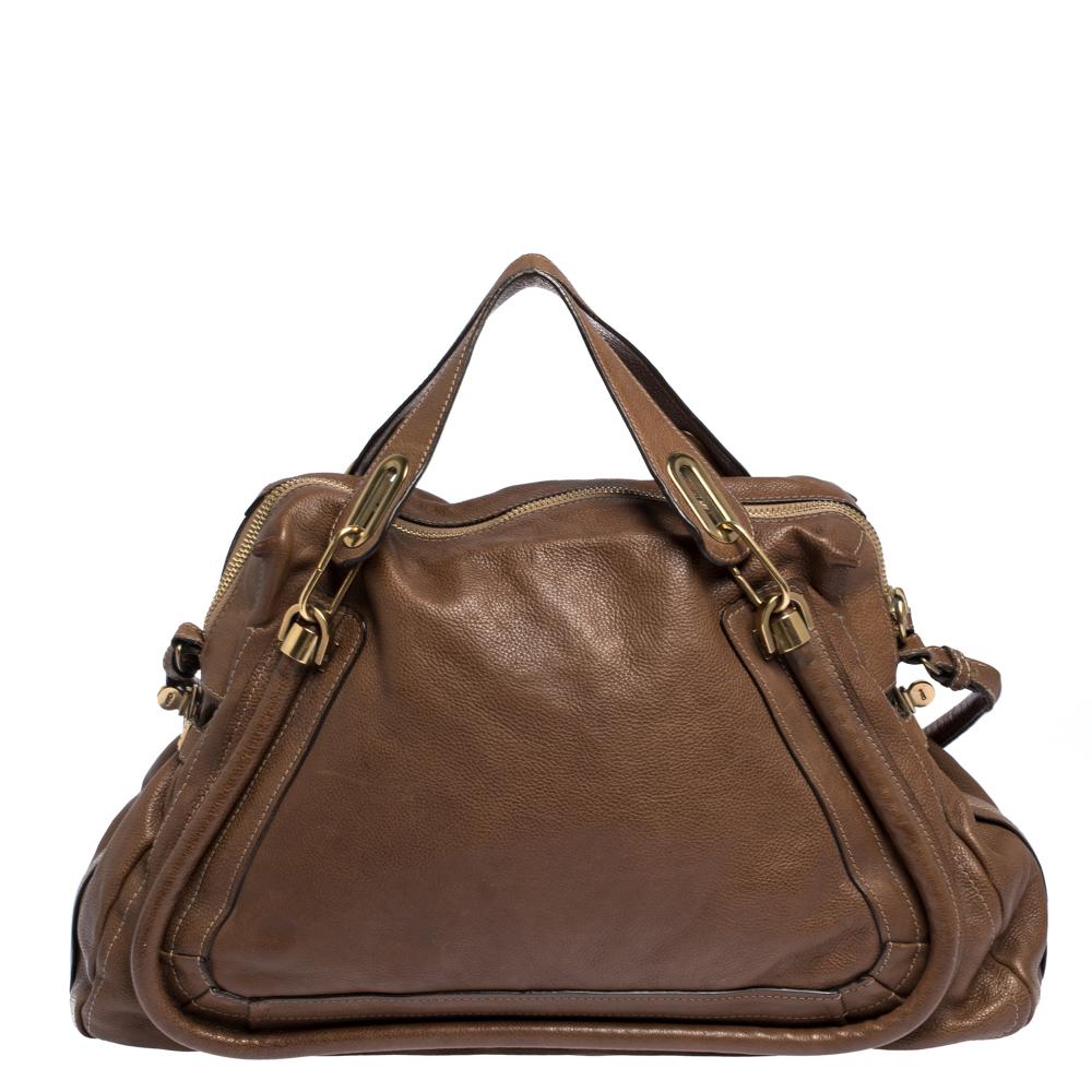 Perfect to flaunt and built to last, this satchel bag by Chloe is a worthy buy. It has been crafted from leather and styled with a strap and gold-tone hardware. The bag has two top handles and a spacious fabric-lined interior that will hold all your