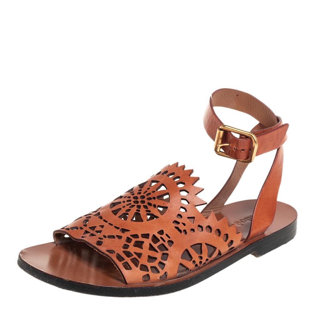 Elevate your outfits with these stylish sandals by Chloe. Crafted in Italy, they are made from quality leather and come in a lovely shade of brown. They feature open toes, laser-cut vamps. buckled ankle straps and gold-tone hardware. They are