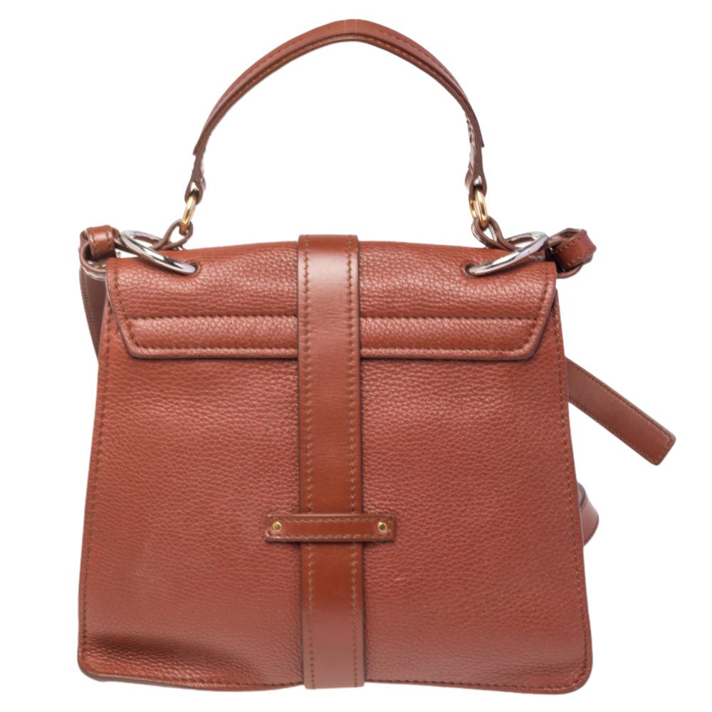With an affinity to create chic bags that look like works of art, Chloe brings this Aby Day bag that is just a masterpiece. Crafted from leather, it presents itself in a brown hue. It is styled with a front flap that carries a padlock and opens to a