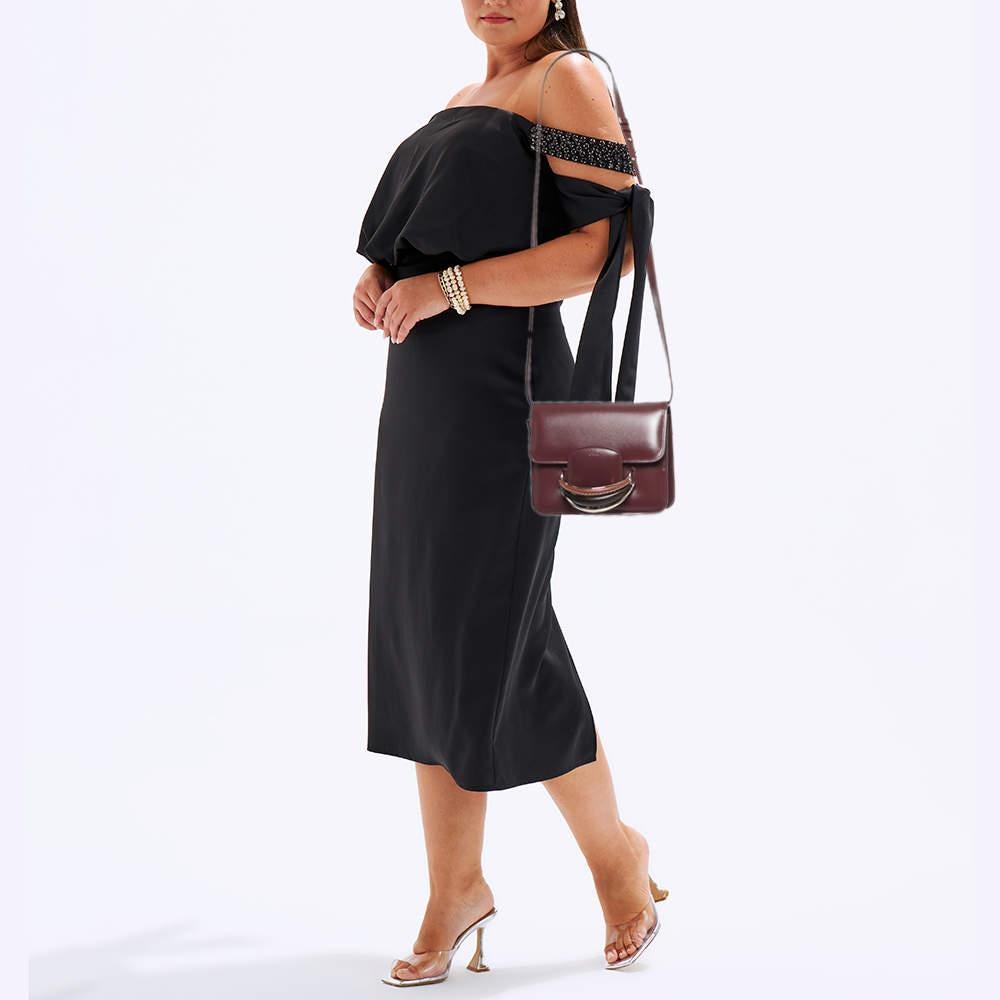 The Chloé bag is a chic accessory that effortlessly combines style and functionality. Crafted from rich burgundy leather, it features a compact yet spacious design with a structured silhouette. The adjustable crossbody strap offers versatility,