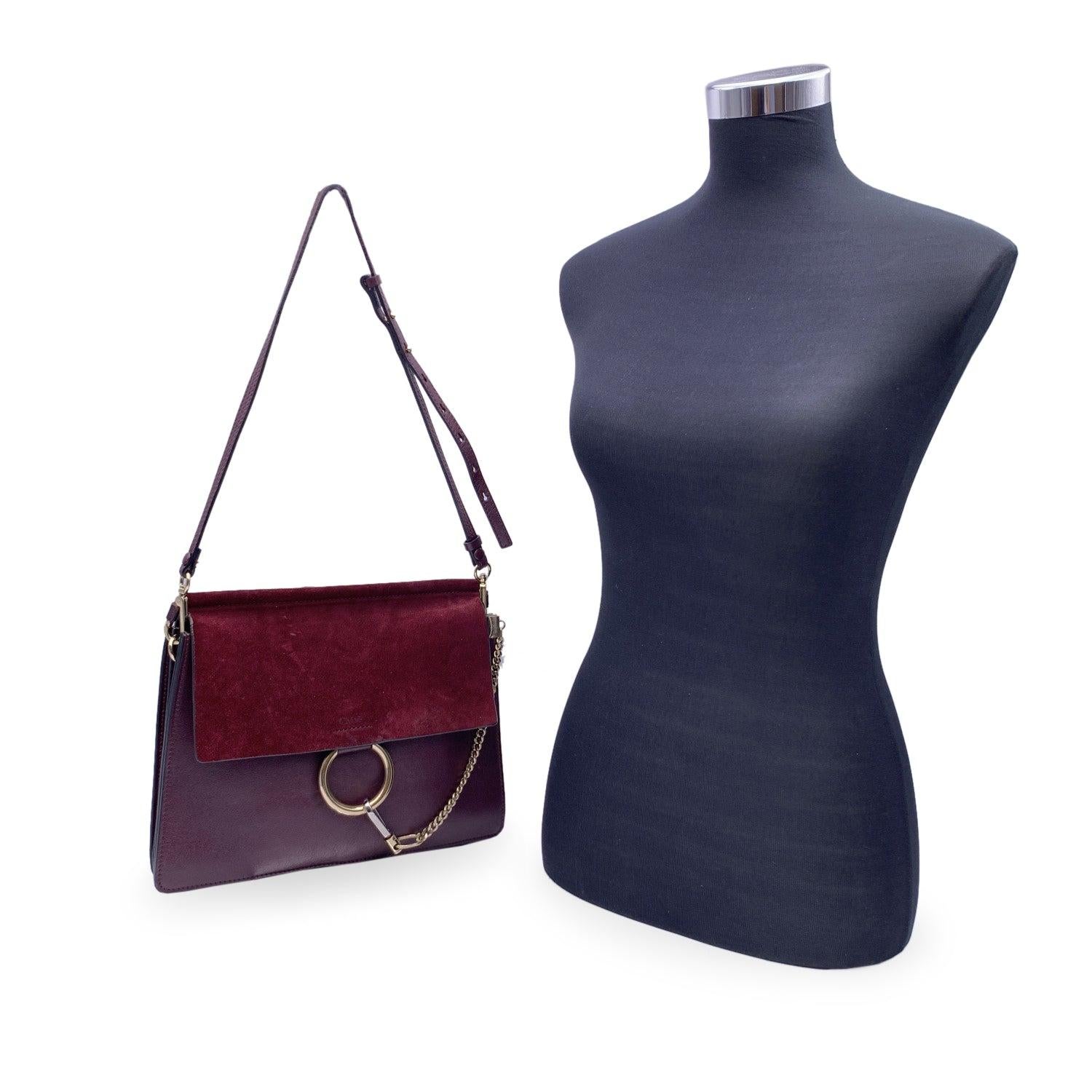 This beautiful Bag will come with a Certificate of Authenticity provided by Entrupy. The certificate will be provided at no further cost. Chloé Faye shoulder bag in burgundy suede and leather. The Faye was created for the 2015 spring/summer