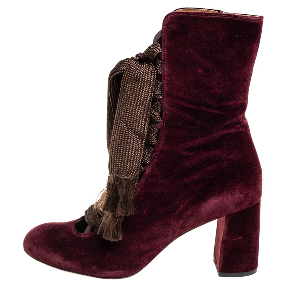 Chloé's burgundy velvet Harper boots fasten with lace-up ribbons that exude a feminine Victorian appeal. They have round toes and are finished with block heels, making them easy to wear from day to night.

