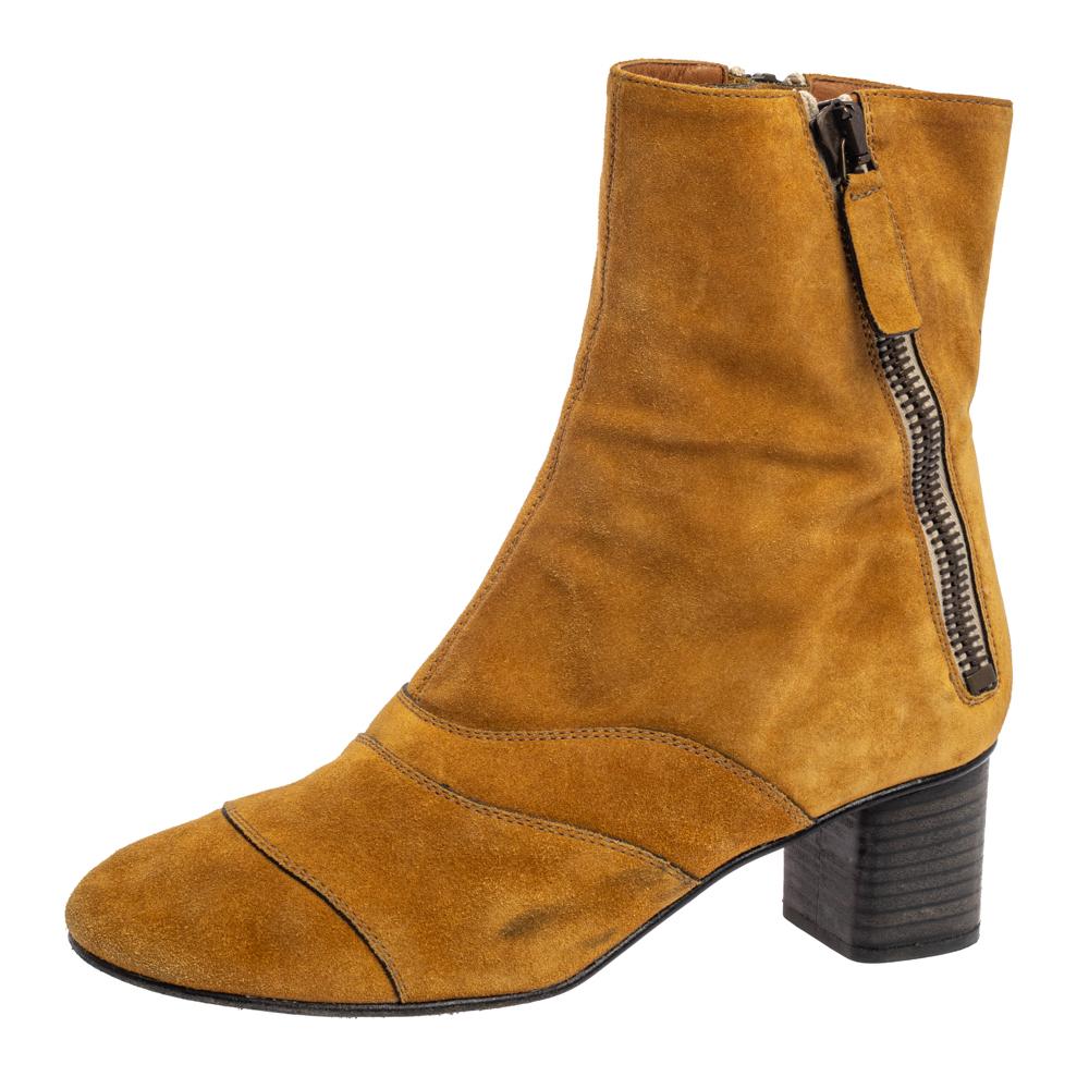 Let these ankle boots from Chloe help you shine a little more than others and amaze onlookers with every step! They have been crafted from butterscotch yellow suede and designed with pleated stitch details. They flaunt round toes, zippers on the