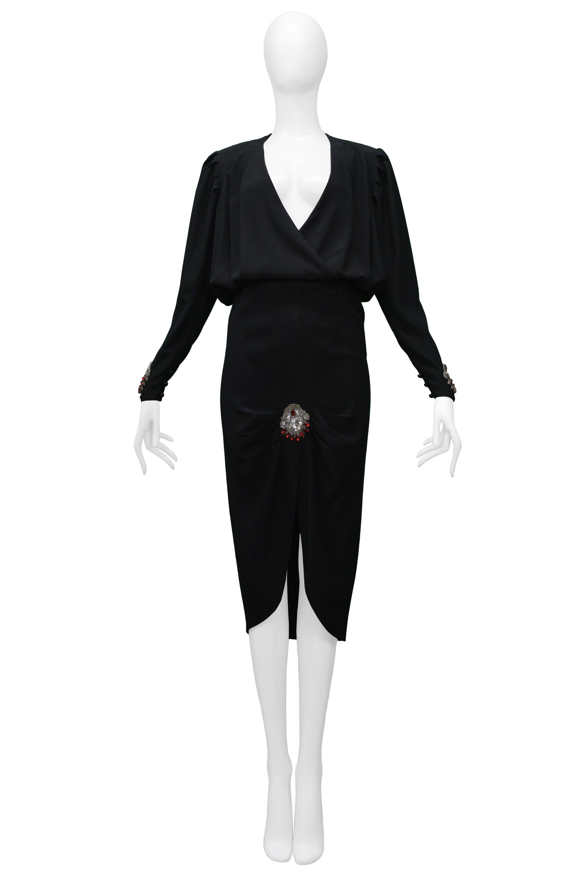 Vintage Chloé by Karl Lagerfeld black skirt ensemble. The jacket features long sleeves, shoulder pads, rhinestones appliques at the cuffs, and wrap over pleated front panels. The skirt features a pencil skirt silhouette, pleating around the