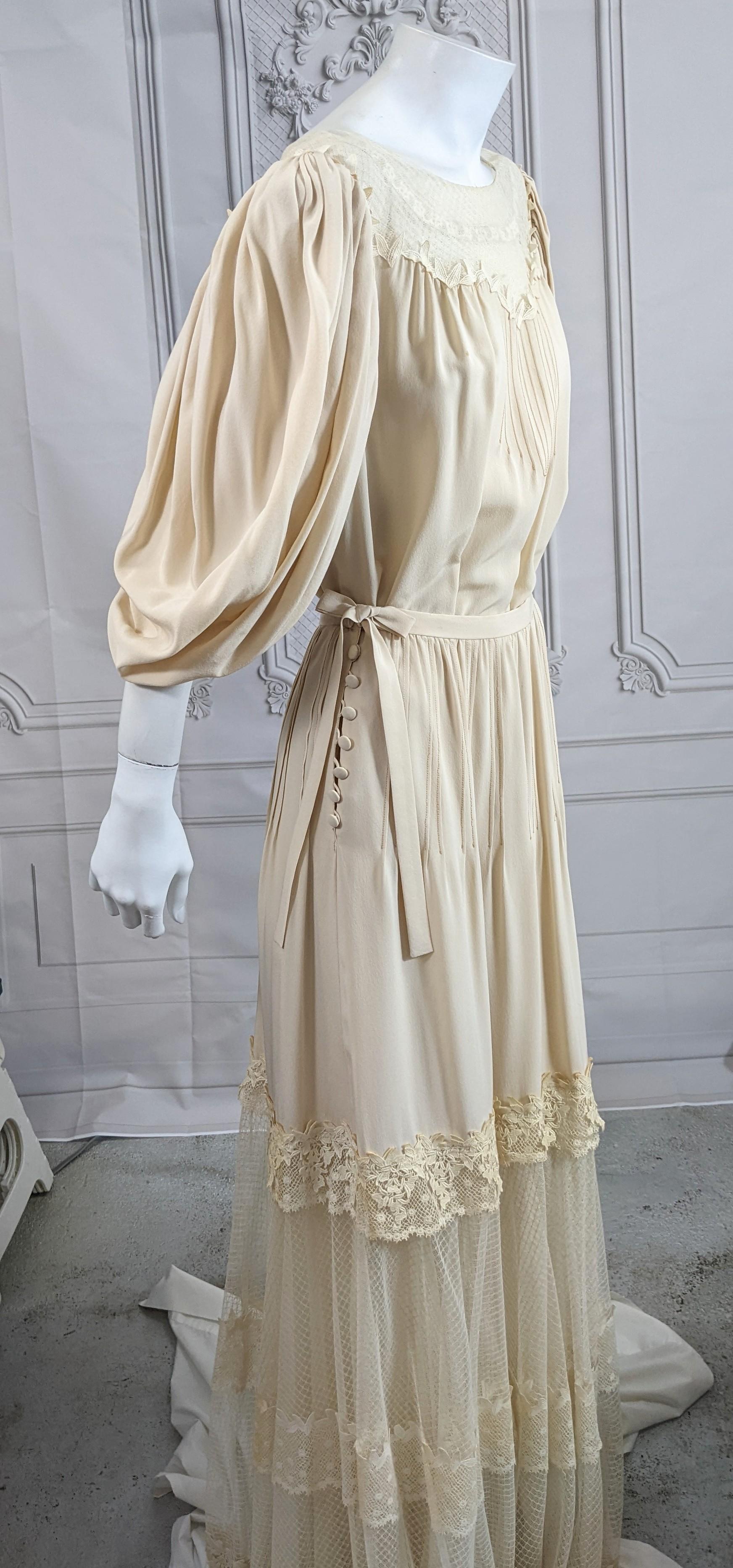 Chloe by Karl Lagerfeld Silk Crepe and Net Edwardian Ensemble from the late 1970's. The ensemble is composed of a floor length gown and overskirt. Both are of nude silk crepe and net with Schiffli lace trim. When worn together, they appear to one